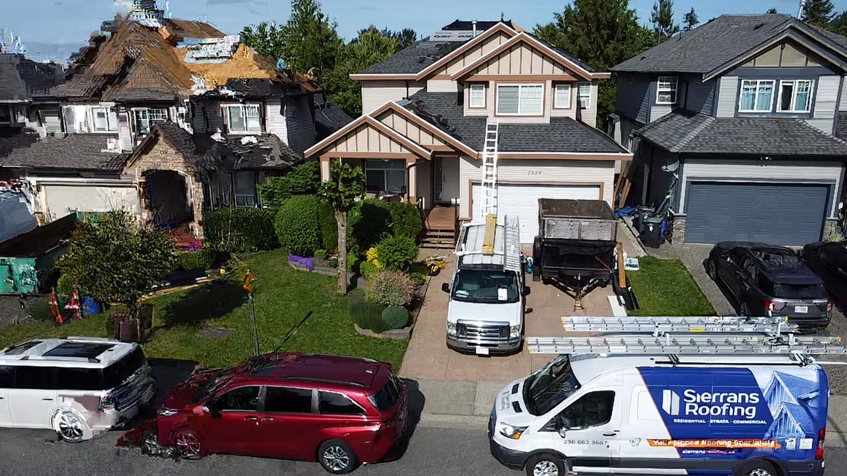 Residential Aldergrove roofing scene showing Sierrans Roofing vans parked with a ladder set for roof access