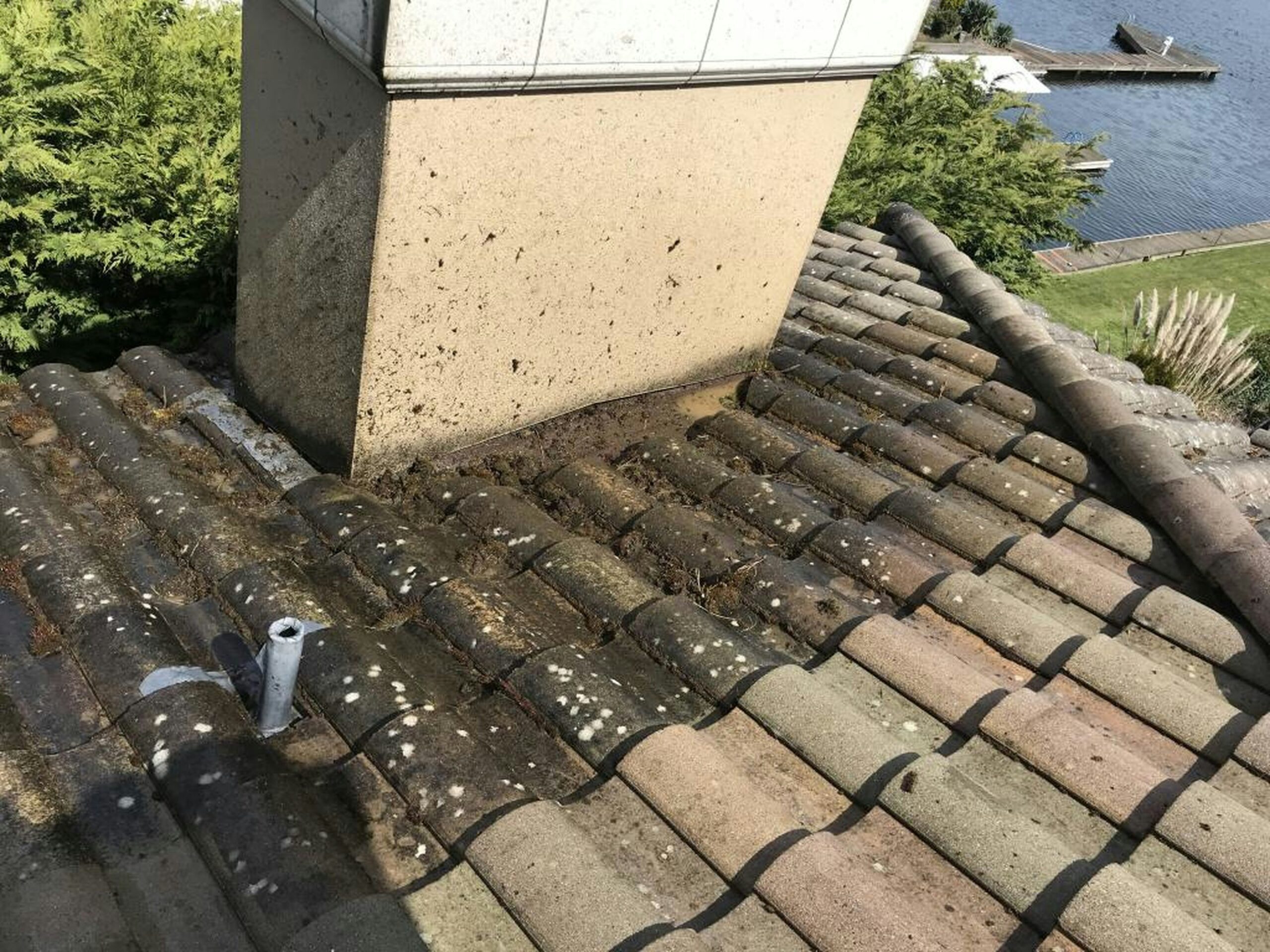 Sierrans Roofing roofing contractor team repairing a residential roof with two skilled workers on site and a company van parked nearby